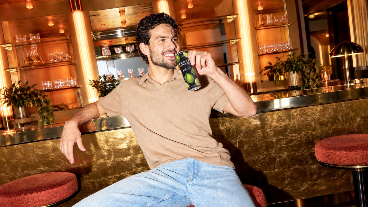 Sitting at a gold bar with a can of AMASS Sparkling Salted Lime